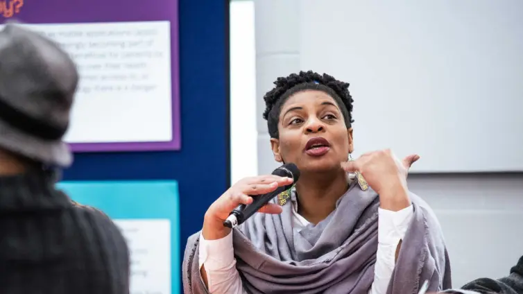 Woman talking on a microphone.