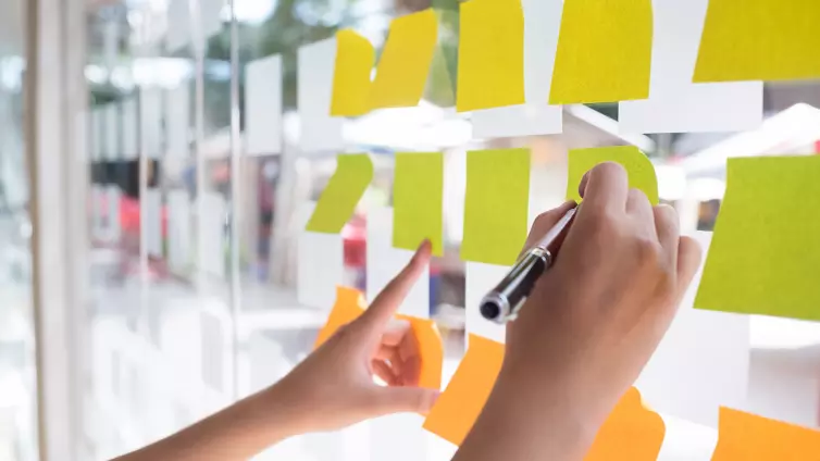 Post-it notes on a glass wall.
