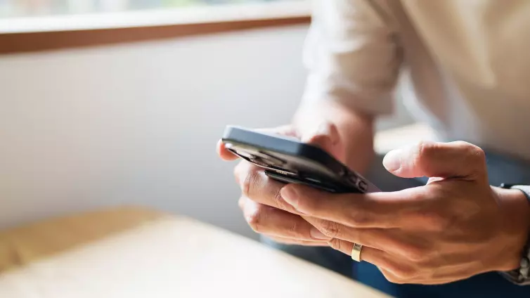 Close up of person looking at mobile phone.